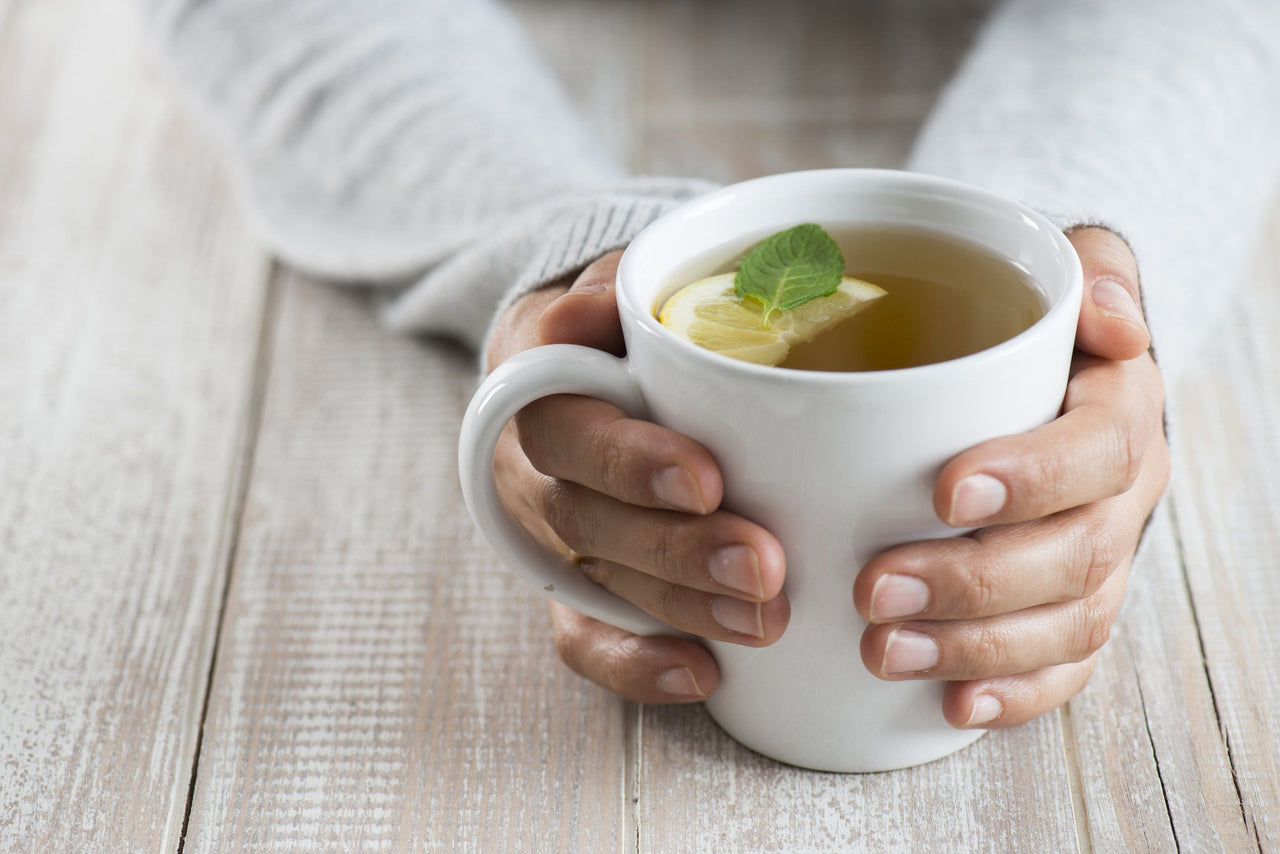 hands holding a mug of herbal tea